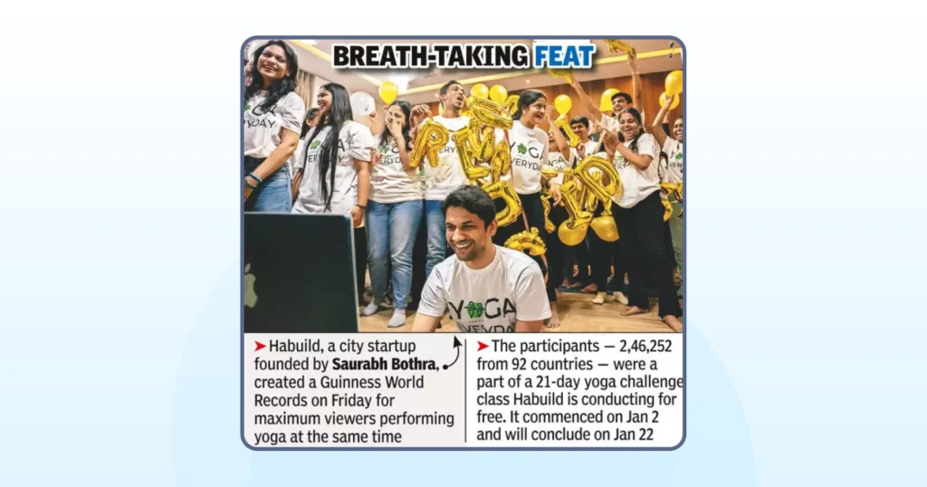 News clipping showing Habuild team celebrating a Guinness World Record yoga session with a large group event.